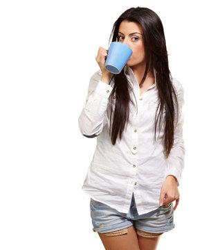 portrait of young woman drinking over white background