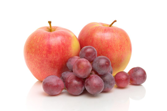 red apples and grapes on a white background