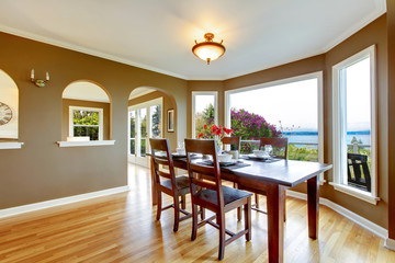 Dining room with brown walls and wood table.