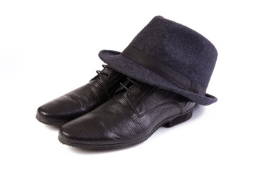 A pair of men's shoes and a classic hat