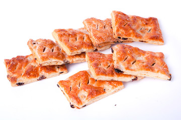 Cookies from flaky pastry with raisin on a white background