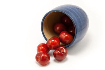 Juicy ruby red cherries in a blue cup