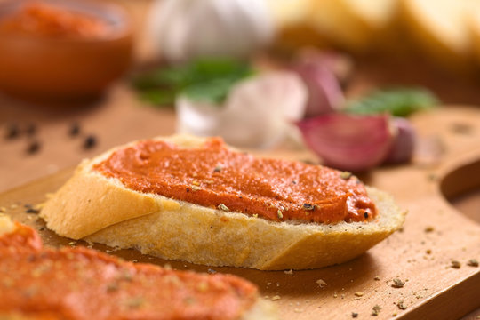 Homemade tomato-butter spread on baguette slices