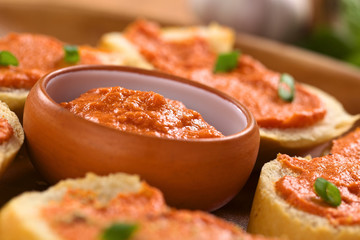omato-butter spread in small bowl with canapes