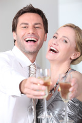 Couple laughing with glasses