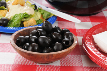 Black olives on a picnic table