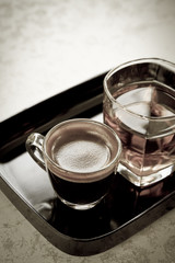 Coffee and tea in black plate