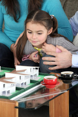 couple and little girl having their house built