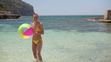 Happy woman throwing beach ball into camera lens, slow motion - Powered by Adobe