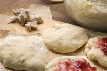 Dough with marmelade on wooden board