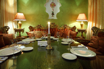 candlestick with candle at glass table with serving