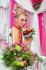 beautiful young bride with bouquet of red roses