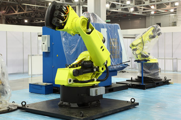 two big new yellow robots for automotive industry at exhibition