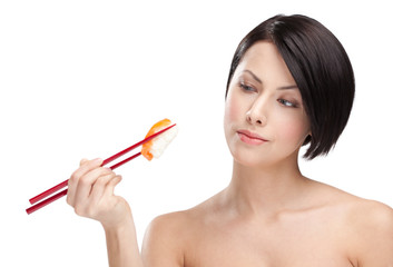 Brunette woman holding sushi with a chopsticks