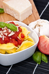 Tortellini in a bowl with ingredients