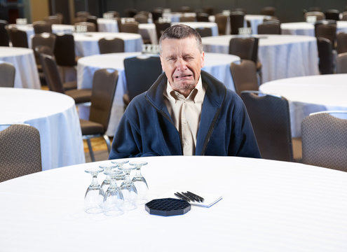 Man crying in empty conference room