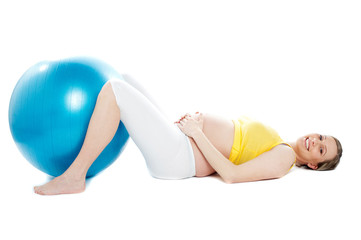 Fototapeta na wymiar Beautiful pregnant woman lying with exercise ball