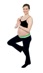 Beautiful pregnant woman doing yoga