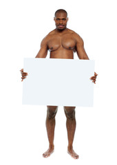 Naked man hiding behind blank white billboard