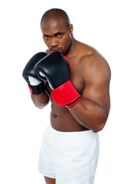 Shirtless African Boxer Aiming To Punch You