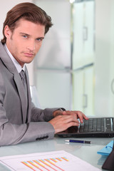 Fototapeta premium Young businessman on laptop