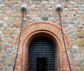 Entrance to hall of castle gates hang on chains