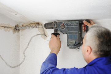 Worker doing job with his drill