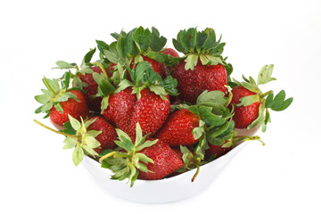 Fresh red strawberries on a white plate