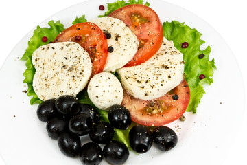 salad in a plate of mozzarella, tomatoes, olives and seasoning