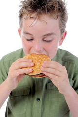 Little boy eating a hamburger