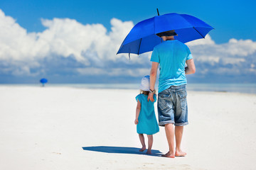 Father and daughter walking at beach