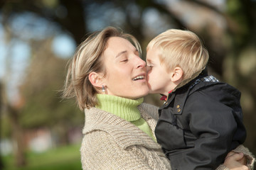 Fototapeta premium portrait of mid adult woman and her little boy outdoors 