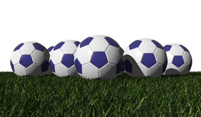 Blue soccer balls on a green grass