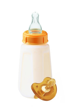 baby milk bottle and dummy isolated on white