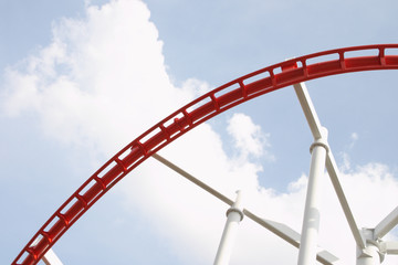 Part curve of red and white roller coaster rail.
