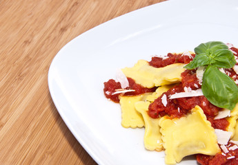 Plate with Raviolis on wooden background