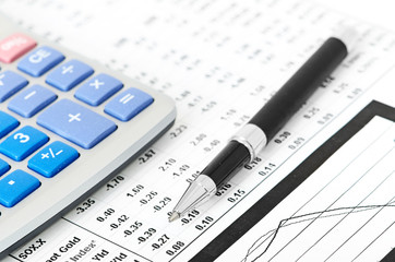 pen and calculator on business paper