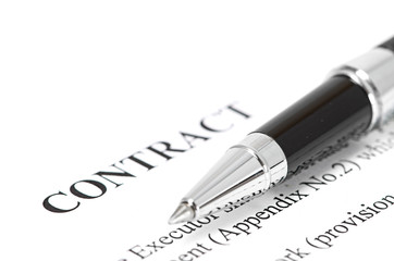 Close-up of silver pen on contract.