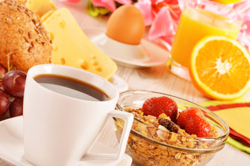 Breakfast on the table. Coffee, orange juice, rolls, muesli.