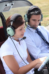 Woman setting a flight plan in an open cockpit