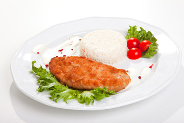 meat with mixed leaf salad an rice on white