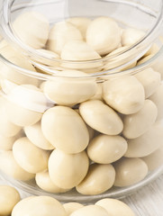 white chocolate balls with almond heart. in a glass jar