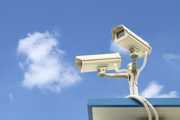 Security camera on blue sky background