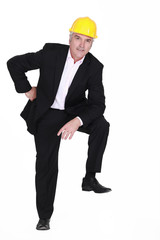 Man with helmet and foot resting on invisible object