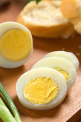 Fresh hard boiled egg cut in slices with scallion