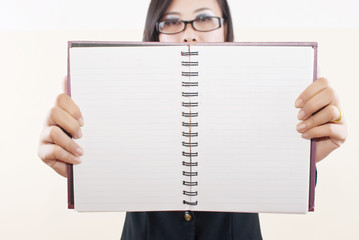 Businesswoman take her blank notebook for business concept.