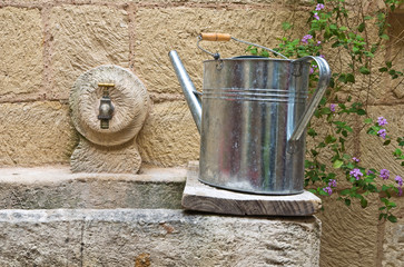 Watering can on washhouse.