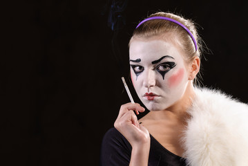 The mime with a cigarette on black background