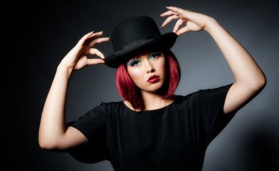 Pretty young auburn haired female with bowler hat
