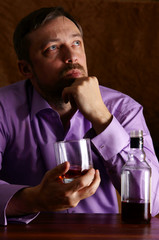 man and whiskey at table